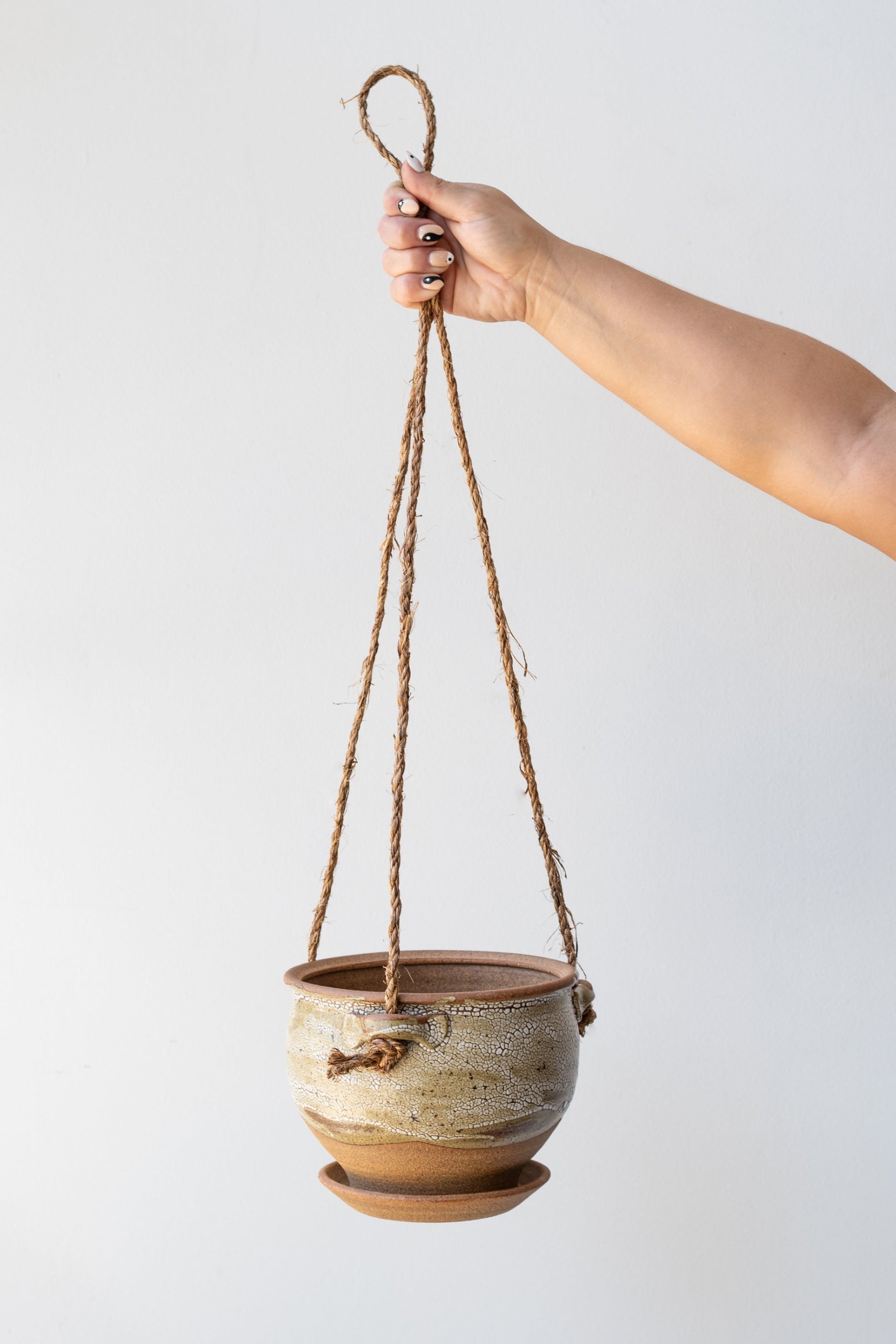 Bruning Pottery Hanging Planter super crackle glaze - 6" held in front of white wall  ©Sprout Home