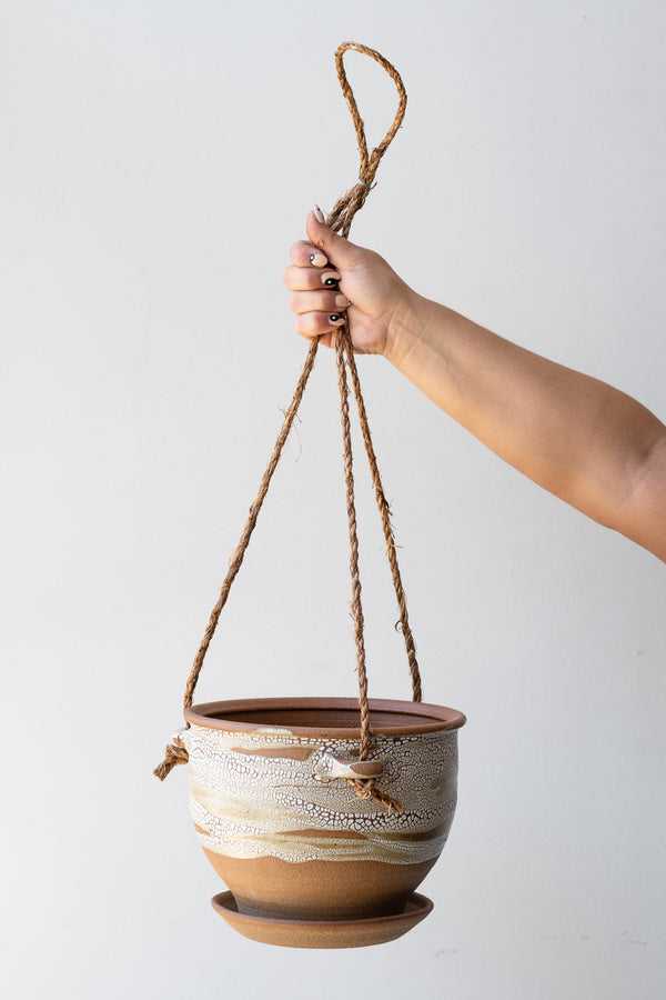 Bruning Pottery Hanging Planter super crackle glaze - 8" held in front of white wall