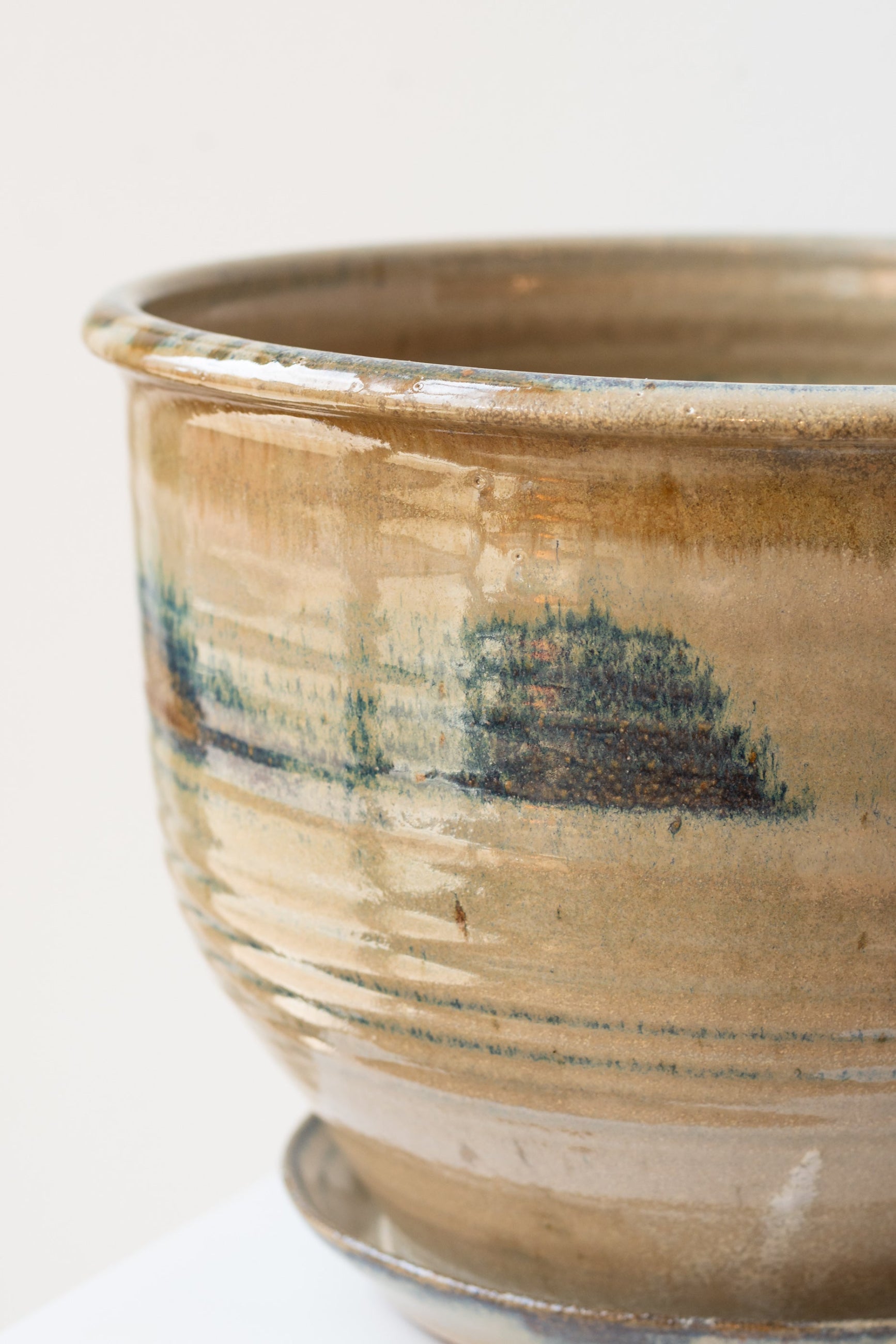 Iron and Ivory glazed pot viewed fro the side detail against white ©Sprout Home