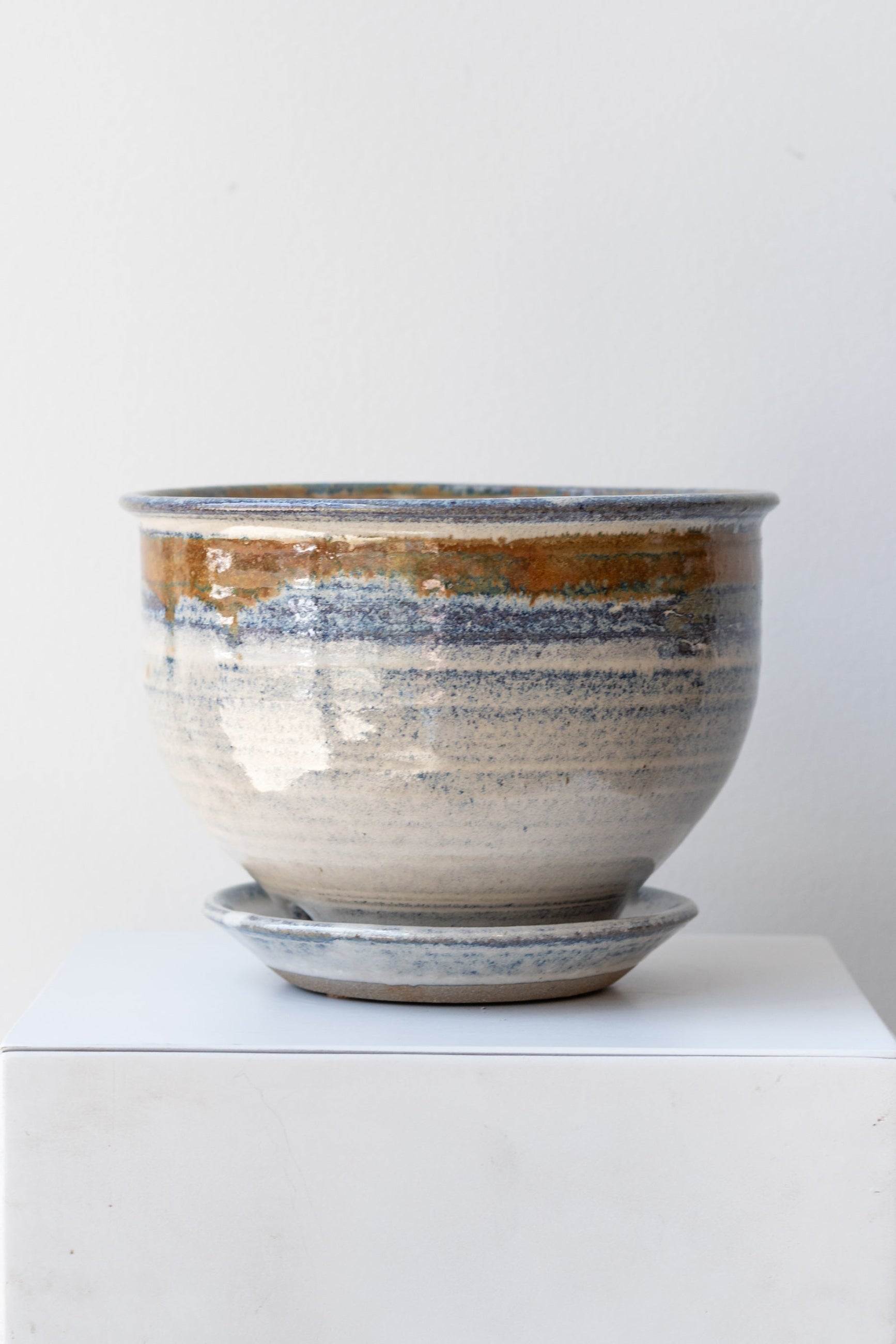 Bruning Pottery Planter ivory & iron glaze - 6" on white surface in a white room ©Sprout Home