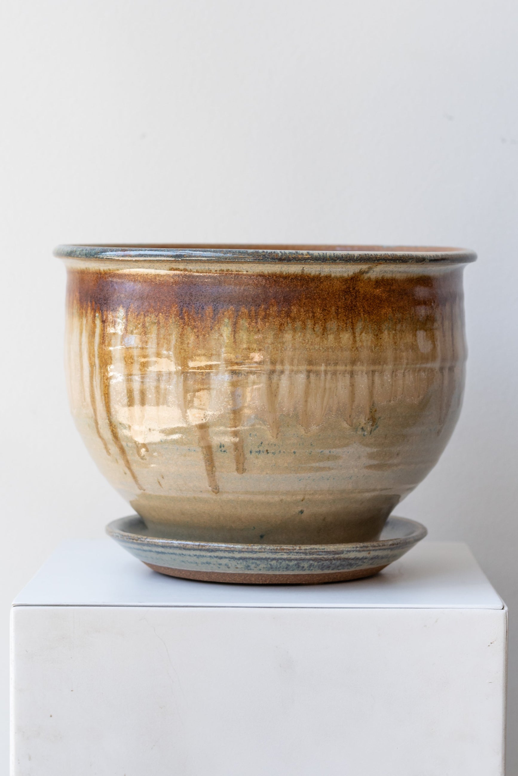 Bruning Pottery Planter ivory & iron glaze - 8" on white surface in a white room ©Sprout Home
