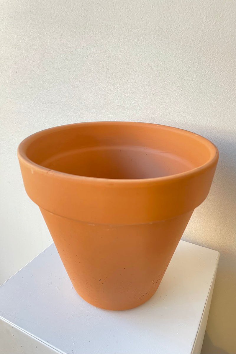 Detail of Clay Standard Pot Terracotta 8.3" against a white wall