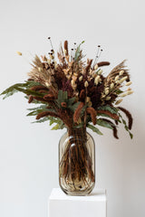 "Allspice" autumnal preserved floral arrangement by Sprout Home in grey retro glass vase in front of white background