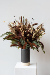 "Allspice" autumnal preserved floral arrangement by Sprout Home in black Jacqueline vase by Little Fire Ceramics in front of white background