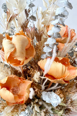 A close-up view of the $200 option for Preserved Arrangement Creamsicle by Sprout Home against a white backdrop