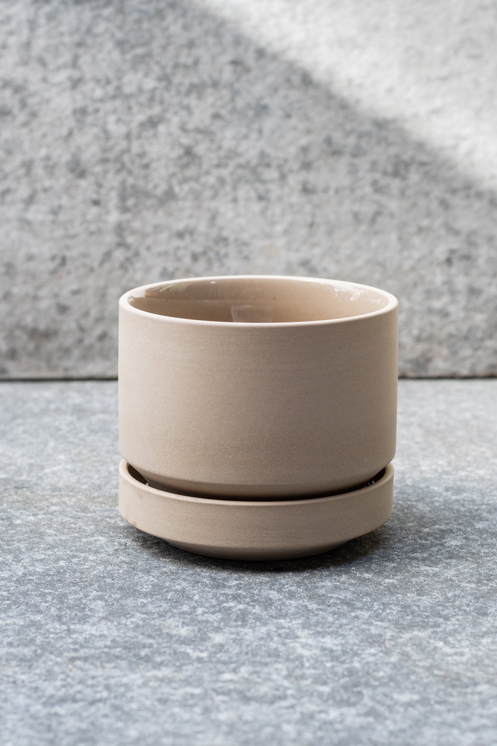 Beige stoneware planter with matching saucer by LBE Designs