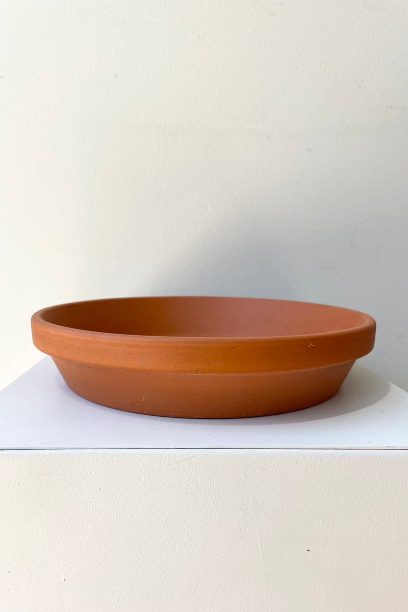 Clay Saucer Red to fit 10" against a white wall