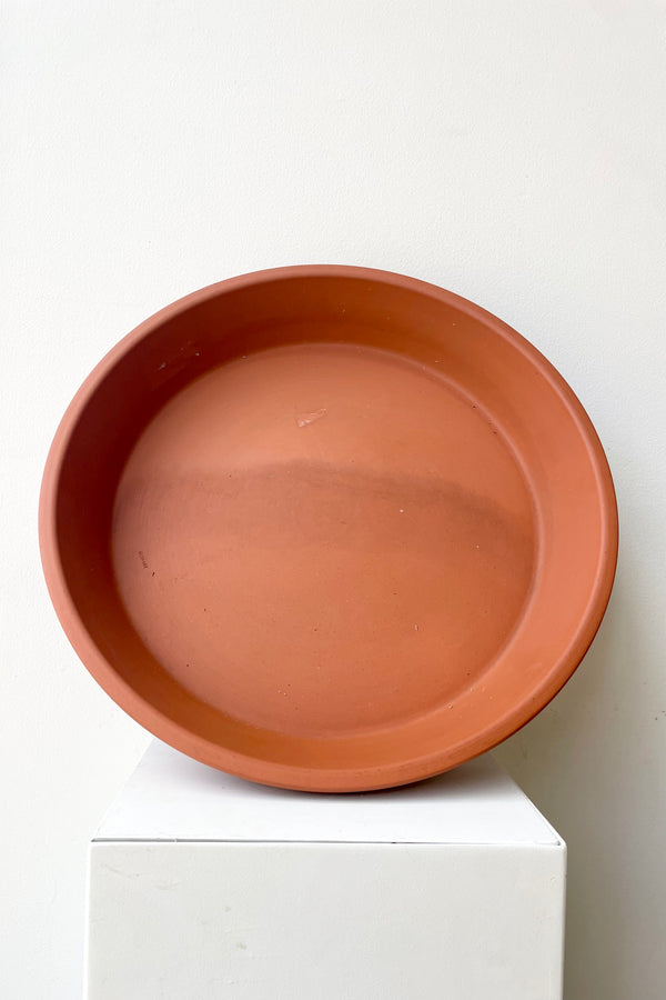 Clay Saucer Red to fit 16" against a white wall