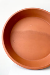 detail of the Clay Saucer Red to fit 16" against a white wall