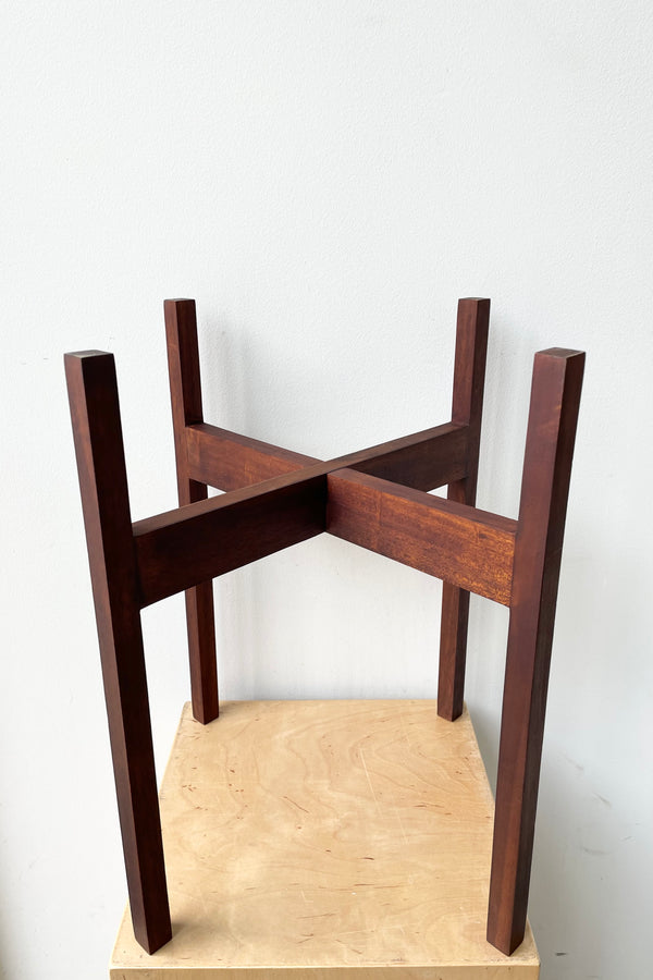 The 12" hardwood stand on plywood against a white wall. 