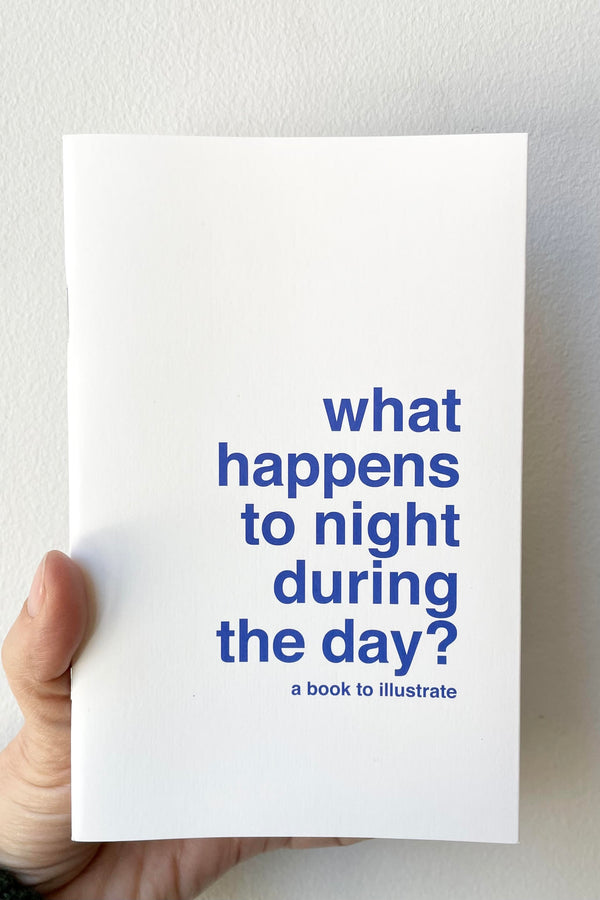 A hand holds the What Happens To Night...? - Book to Illustrate against a white backdrop.