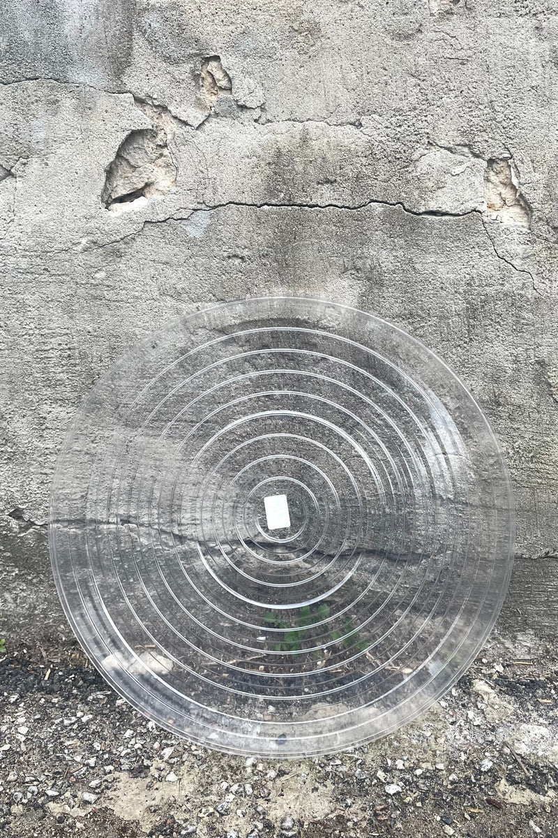 A full overhead view of Plastic saucer 17" against concrete backdrop