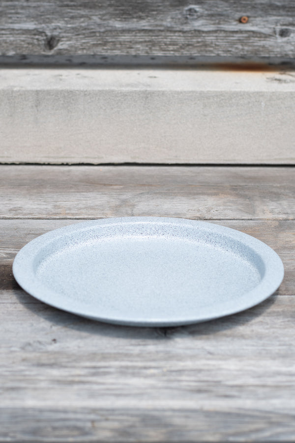 10" multi granite metal plant saucer on a grey wood surface