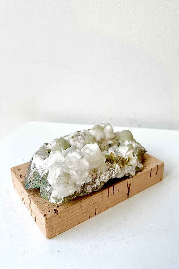 Cork Soap Dish with a crystal on top the same shape a soap against a white wall 