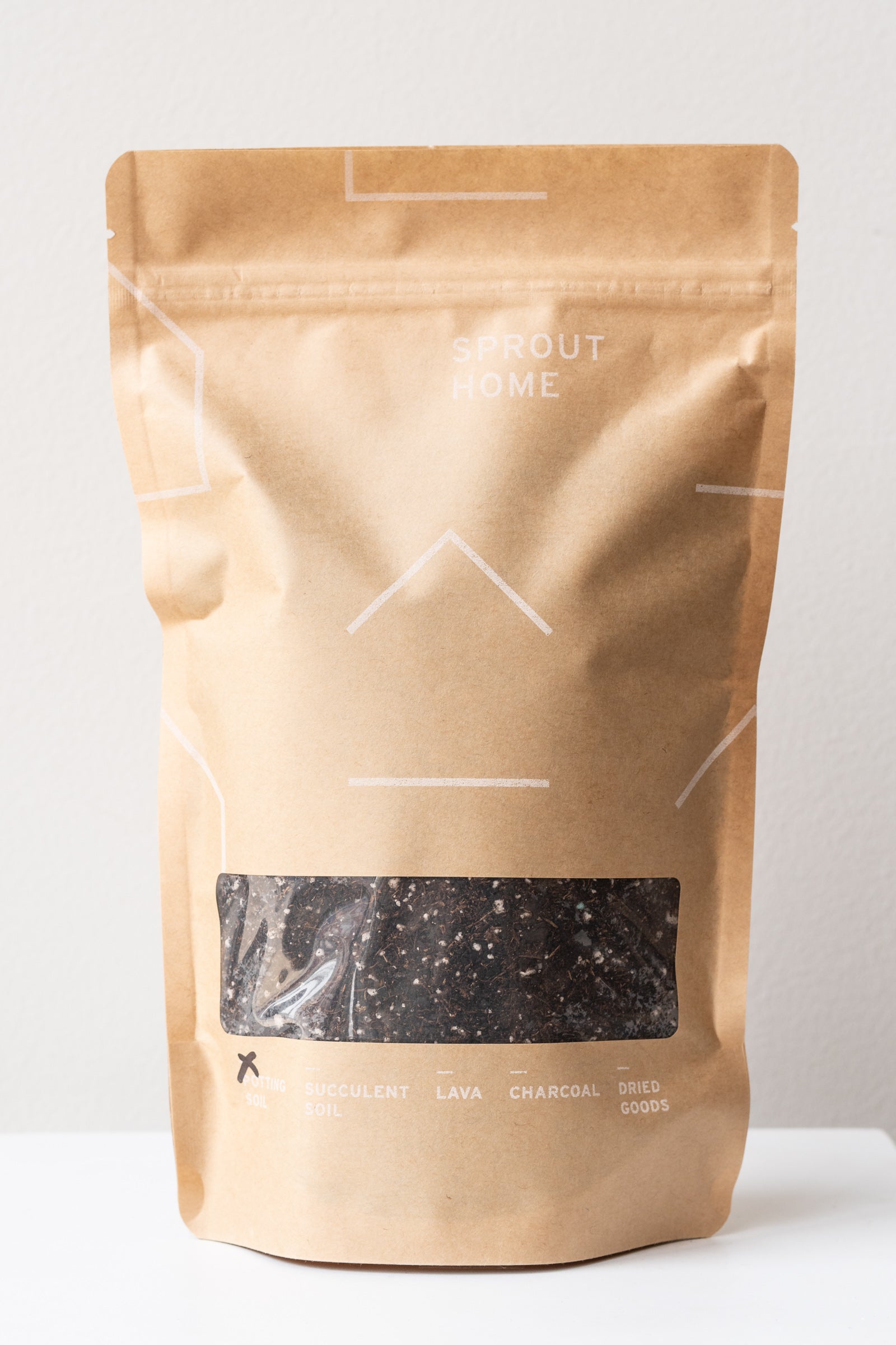 A Sprout Home Pop-up bag of potting mix in the Sprout Home Kraft quart bag. 