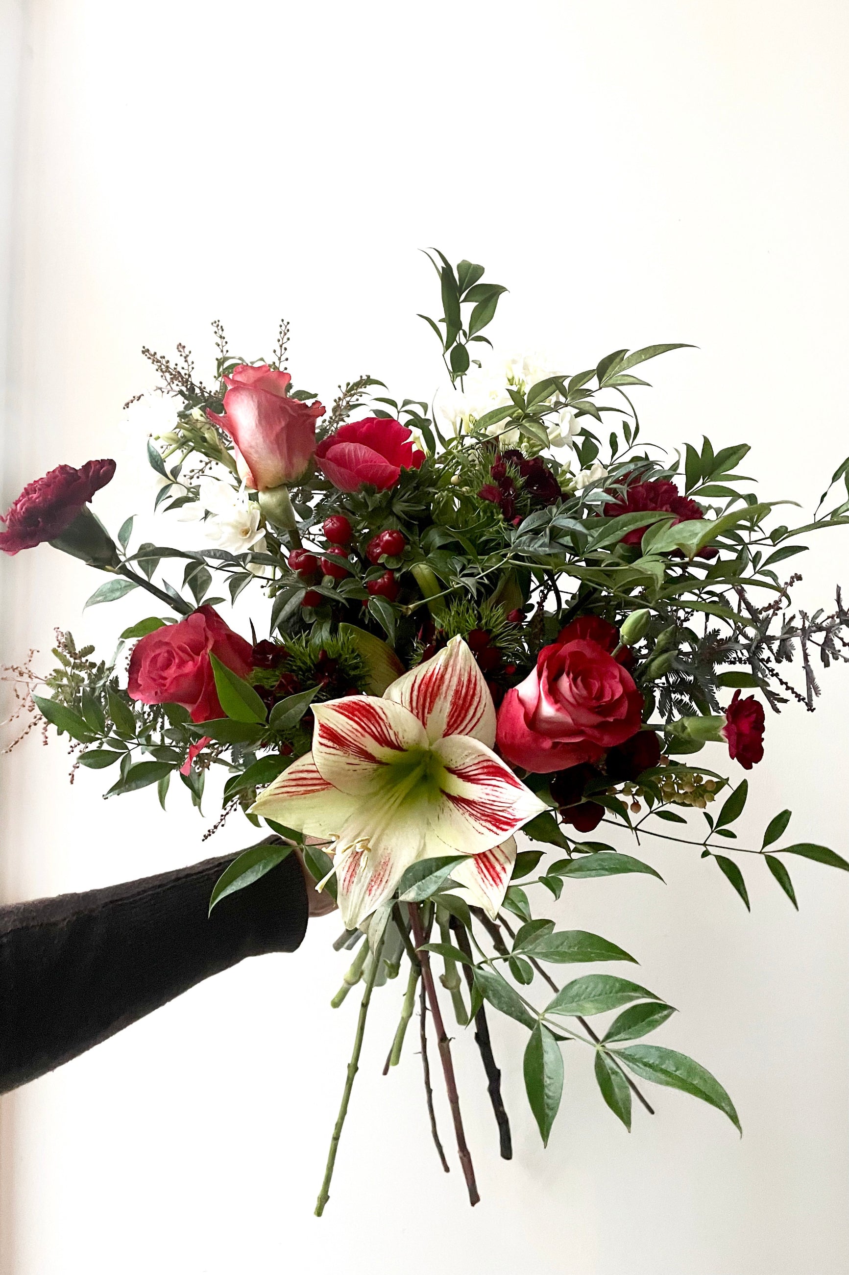 A hand holds an example of fresh Floral Arrangement Solstice from Sprout Home Floral in Chicago ©Sprout Home #size_$75