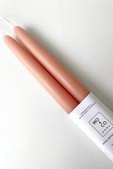 A detailed overhead view of Terra Cotta 14" Taper Candles, pair against a white backdrop