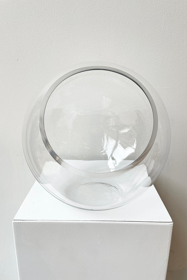 Glass Hurricane Terrarium 9" with an opening on the side against a white wall