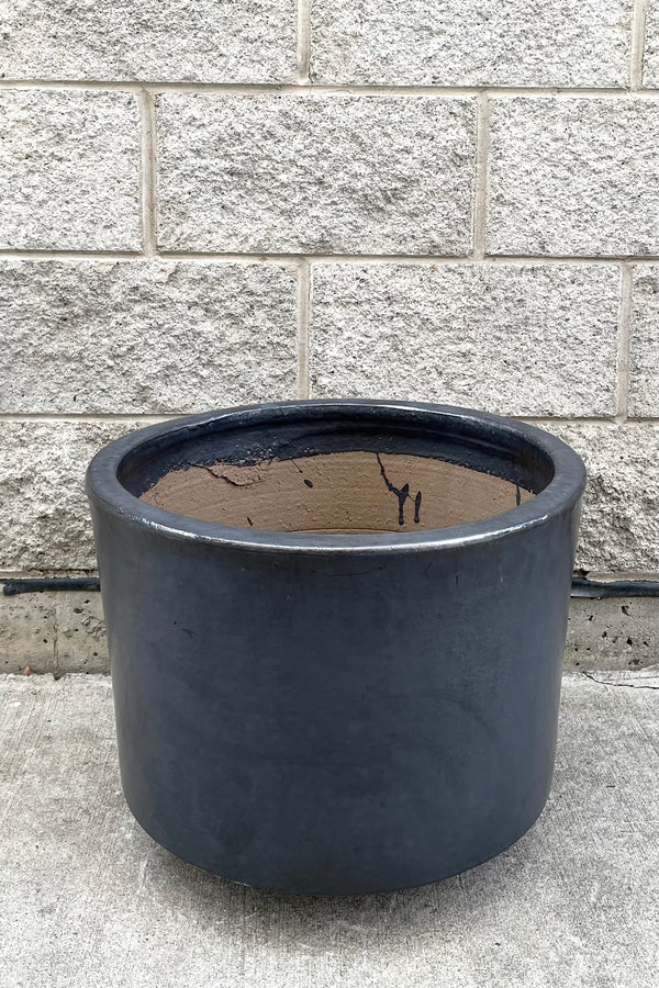 A full frontal view of Lara Graphite Planter Large against concrete backdrop