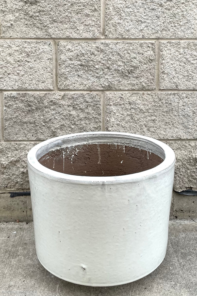 A full frontal view of Lara Oyster White Planter Large against concrete backdrop