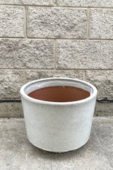 A full frontal view of Lara Oyster White Planter Medium against concrete backdrop