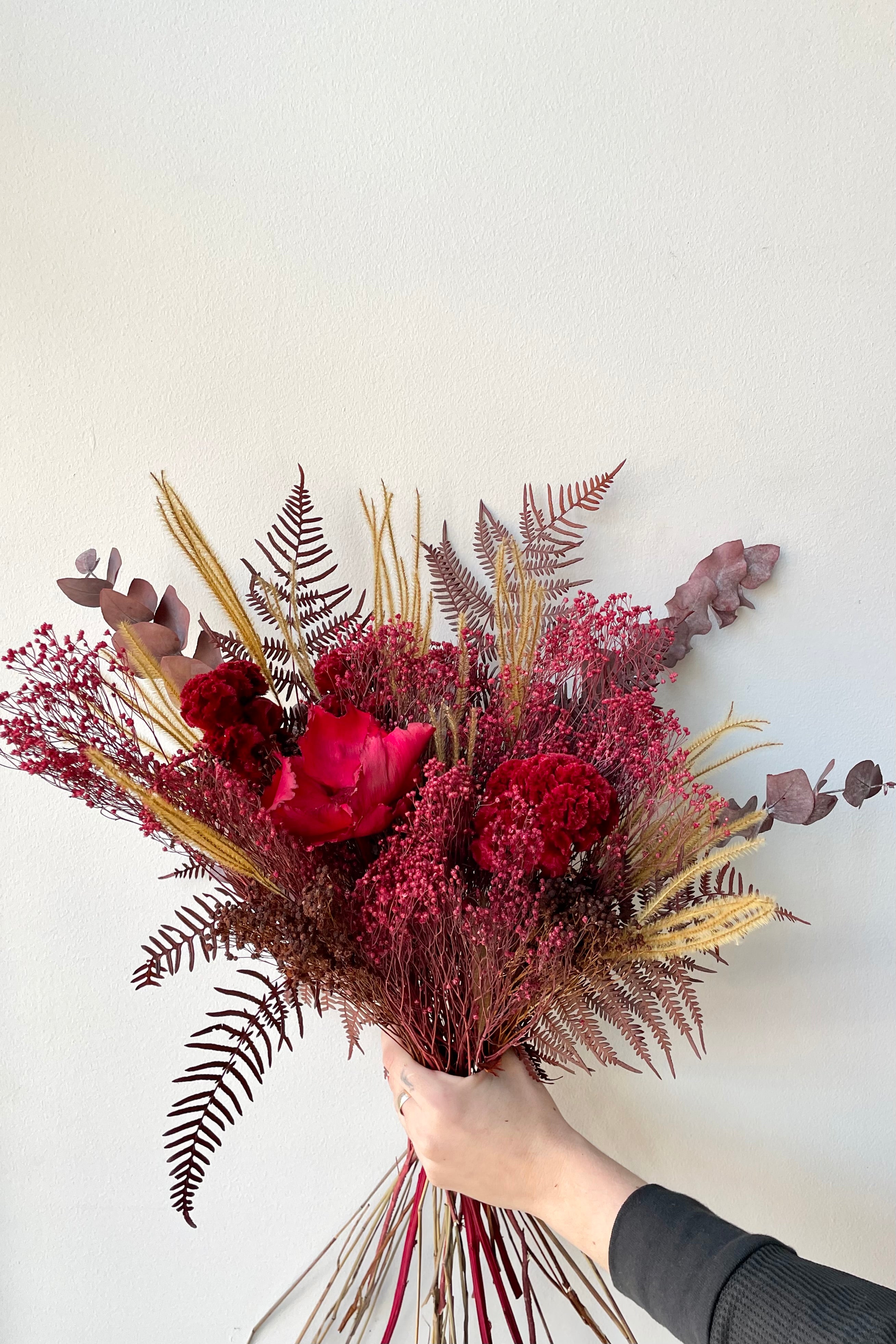 Preserved Red Velvet arrangement against a white wall #size_$85