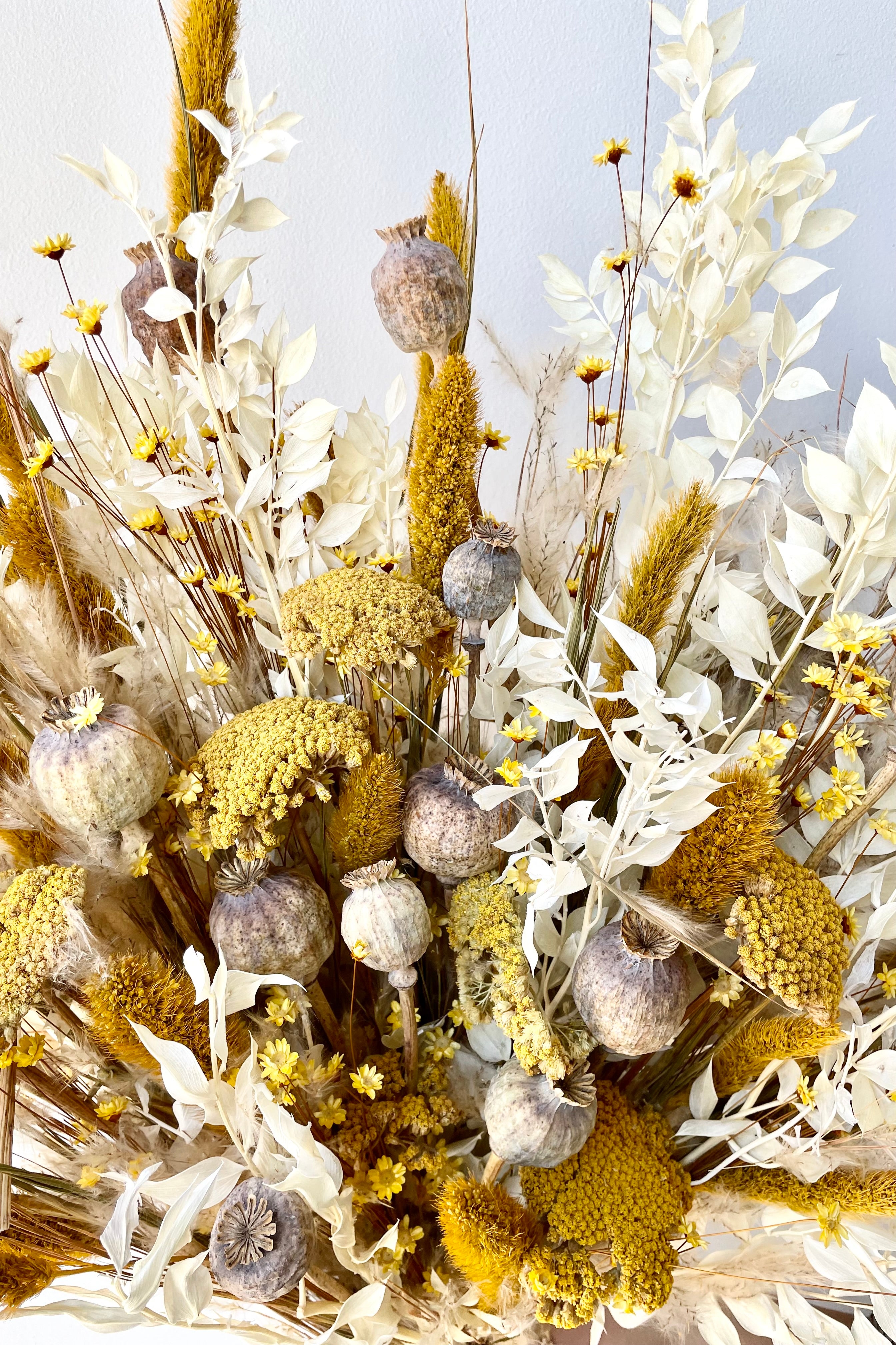 Textured dried floral arrangement that reaches and moves through the image. Vibrant colors of yellow, white and tan. #size_$160