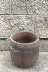 A full frontal view of Dora Planter Small against concrete backdrop